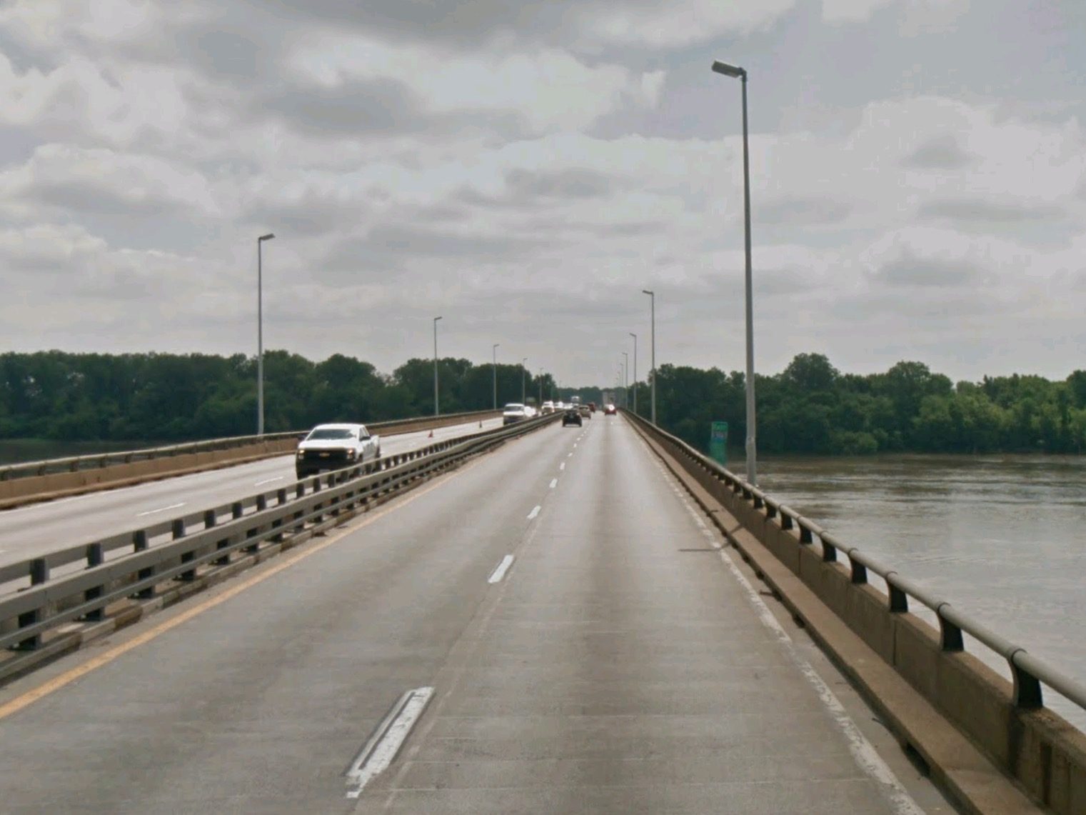 Looking east along the Interstate 270 New Chain of Rocks Bridge over the Mississippi River on an overcast day, a few cars ahead in the lanes.